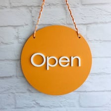 A storefront displaying an OPEN sign.
