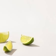 Whole and sliced green limes