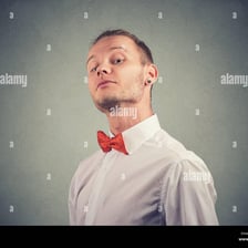 A person posing with an exaggeratedly self-important expression