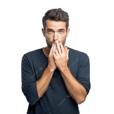 A person holding one finger to their lips to request silence.