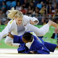 Judo competitors facing each other on an Olympic-style mat