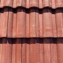 Overlapping slate tiles covering a roof.