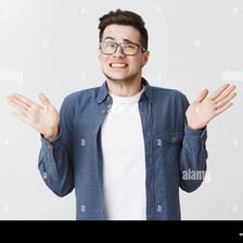 A person making a small apologetic gesture after an apparent mistake