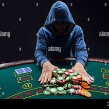 A poker player pushing all their chips into the center of the table.