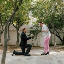 A person kneeling on one knee during a marriage proposal.