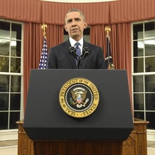 Barack Obama speaking at a podium.