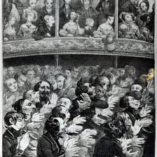 An audience applauding a performer after a show