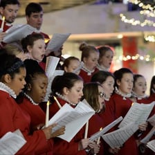 A choir singing Christmas carols.