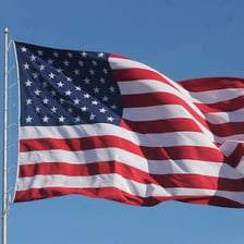The United States flag, commonly called the Stars and Stripes, waving outdoors
