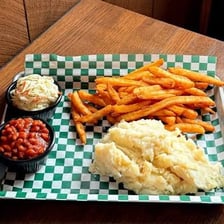 French fries and coleslaw served as side dishes beside a main course