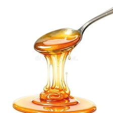 Thick honey slowly dripping from a spoon