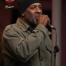 A comedian performing a repeated joke for an audience