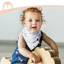 A baby wearing a bib while sitting for a meal.