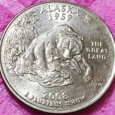 The Alaska state quarter showing a grizzly bear catching a salmon.