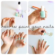 A fingernail being painted with a small brush and polish
