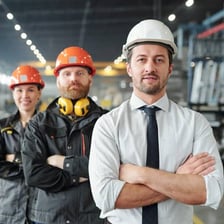 A prominent business leader overlooking an industrial operation