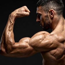 A person flexing a bent arm to display the biceps