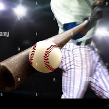 A baseball bat making contact with a ball.