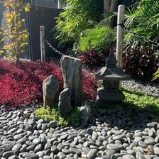 A minimalist Japanese Zen rock garden with raked gravel
