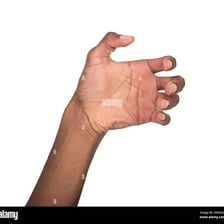 A hand reaching quickly to seize an object.
