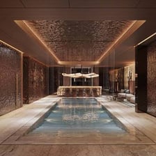 A luxurious spa retreat featuring a treatment room and a relaxing pool.