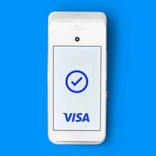 A smartphone held against a contactless payment terminal.