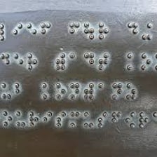 Raised Braille dots visible on a tactile sign