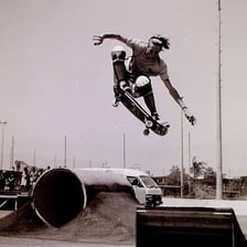 A skateboarder and board airborne during an ollie.