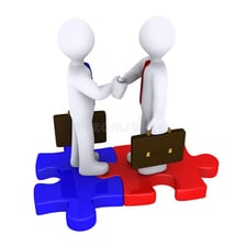 Representatives of two teams joining together in agreement
