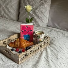 A breakfast tray being served on a bed for Mother’s Day