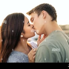A couple sharing an affectionate kiss.