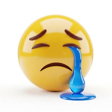 A yellow crying face emoji with blue tears running down its cheeks.