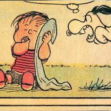 The Peanuts character Linus holding his familiar security blanket.