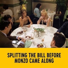 Diners dividing a restaurant bill at a table.