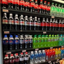 A Coca-Cola Coke can displayed among soft drinks