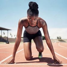 A runner setting off from a starting line.