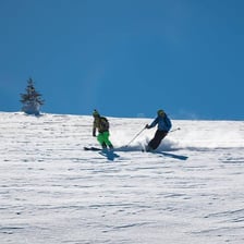 A skier traveling down a snow-covered slope.