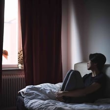 A person sitting alone in a quiet setting.