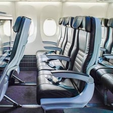 An airplane cabin showing the aisle between rows of seats