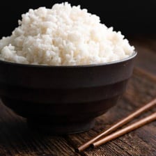 A bowl filled with cooked white rice.