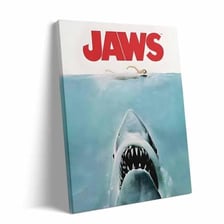The poster for the 1975 film Jaws showing a shark rising toward a swimmer.