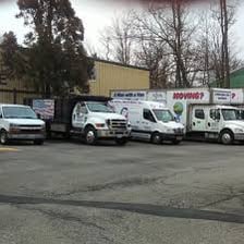 Vans sneakers shown beside a vehicle used for moving.