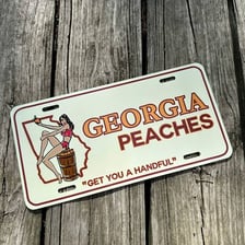 A Georgia vehicle license plate featuring a peach symbol.