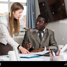 An employee talking with a supervisor in an office