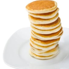 Several pancakes piled on a plate.