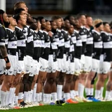 Rugby players from New Zealand competing in a match.