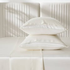 A close-up showing the smooth surface of fine bedsheets.