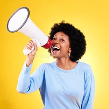 A speaker enthusiastically promoting something to an audience