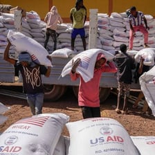 Aid workers distributing supplies to people in need
