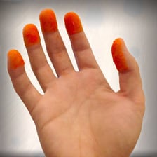 Orange snack seasoning coating a person's fingertips.